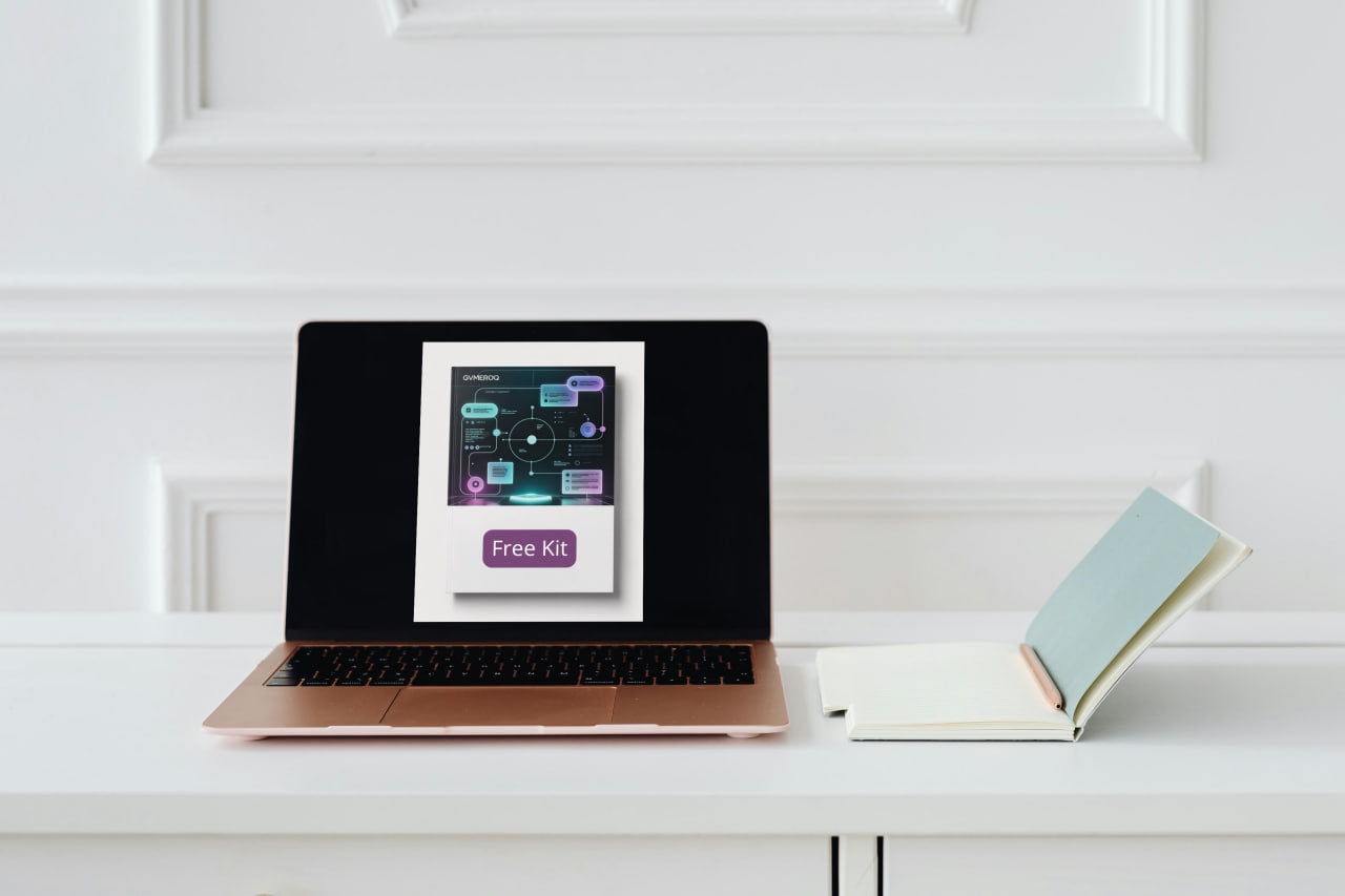 Laptop on a white surface with a screen displaying a free kit offer.
