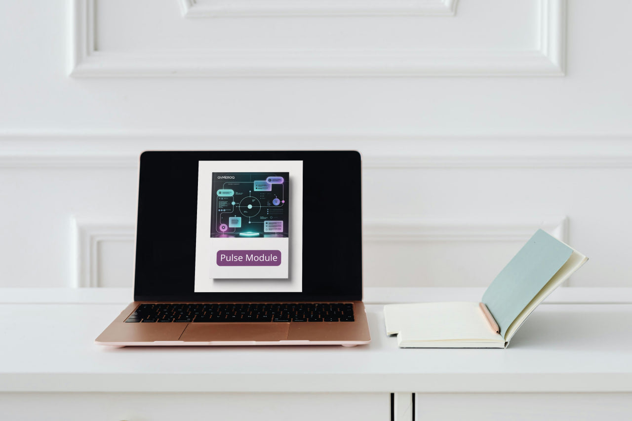 Laptop displaying a product image on a white surface with a book