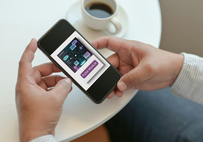 Person holding a smartphone with a music streaming app open, next to a cup of coffee on a table.